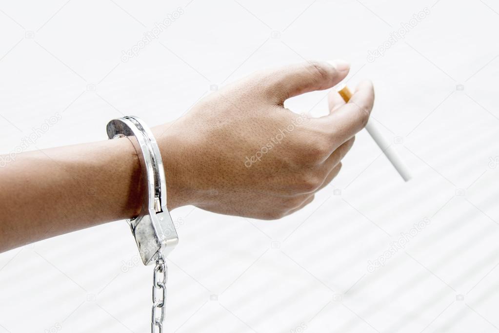 hand with shackle show addict cigarette 