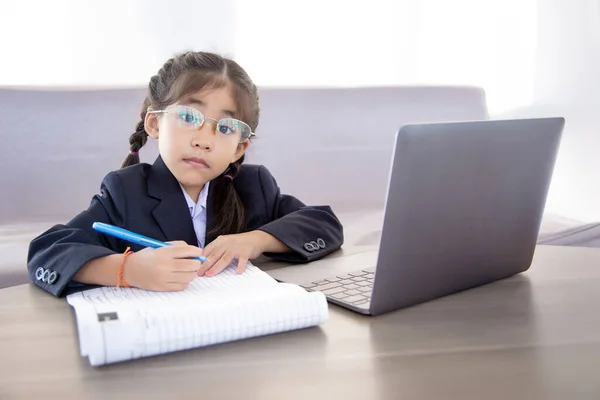 asian kid learning from digital classroom by internet and wireless technology