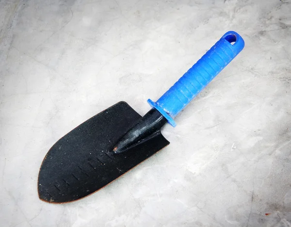 Gardening tools, black iron scoop with plastic handle — Stock Photo, Image