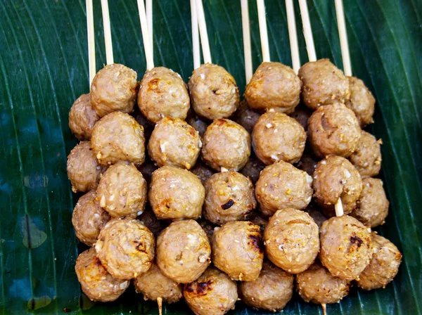 Meat ball with wood stick on banana leaf — Stock Photo, Image