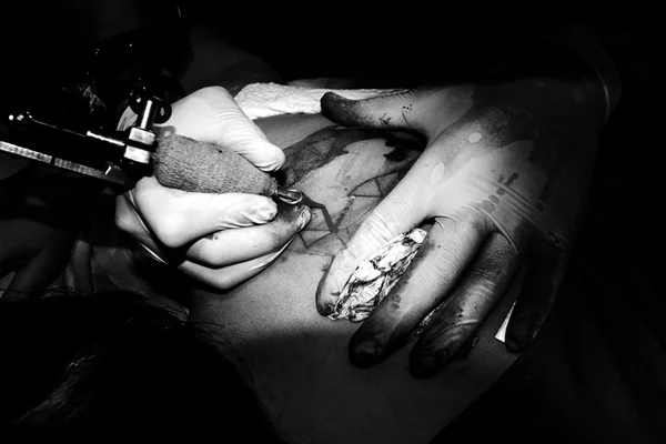 Fabricante de tatuajes hacer tinta negra a la piel —  Fotos de Stock