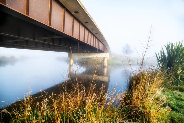 Exploring the Rural Hills of Berwick (south west of Dunedin) at sunrise on a freezing frosty day (-3 degrees)with low mist and fog rolling through between the river and the steel bridge