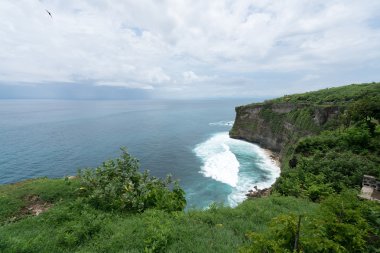 Uluwatu cliff face and the sea, Bali Island clipart
