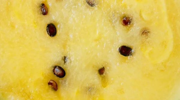 Close-up of yellow watermelon. background. The pulp of a ripe watermelon. watermelon texture. A piece of juicy ripe watermelon. A slice of berries.