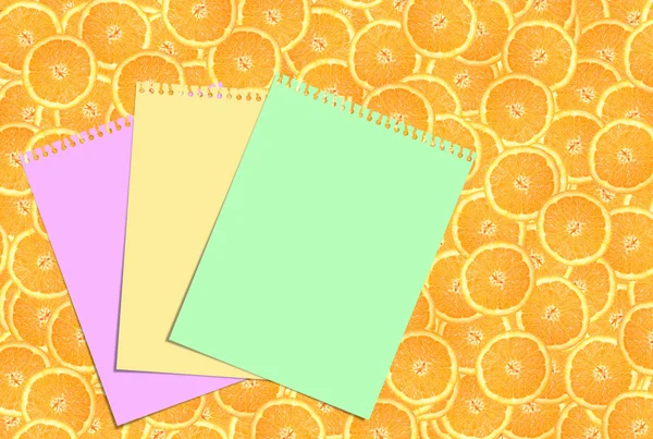 Three sheets of paper against the background of oranges — Stock Photo, Image