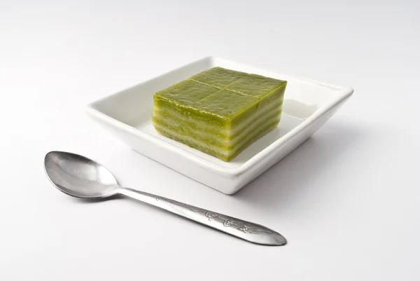 Thai sweetmeat or Khanom Chan is a kind of sweet Thai dessert, in white bowl on white background — Stock Photo, Image