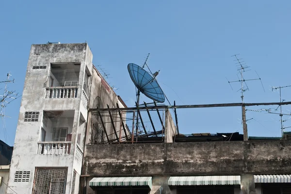 Old buildings tower and satellite dish — Stock Photo, Image