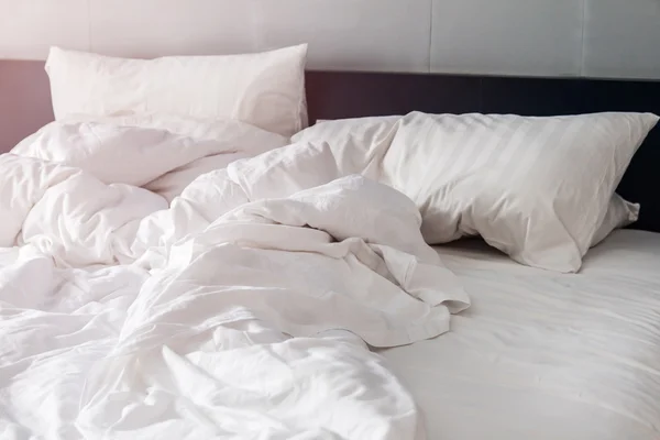 Bed and white pillows with wrinkle blanket in bedroom, from slee — Stock Photo, Image