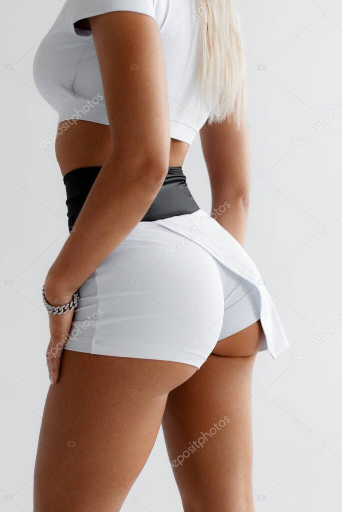 Fitness woman in sportswear. Sporty booty in shorts
