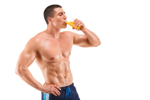 Handsome young muscular man drinking juice isolated on white background — Stock Photo, Image