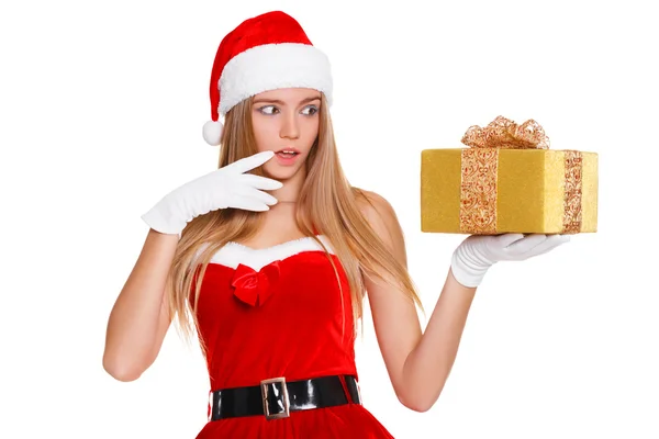 Surprised happy young woman in santa claus clothes looking on christmas gift in excitement. Isolated over white background — Stock Photo, Image