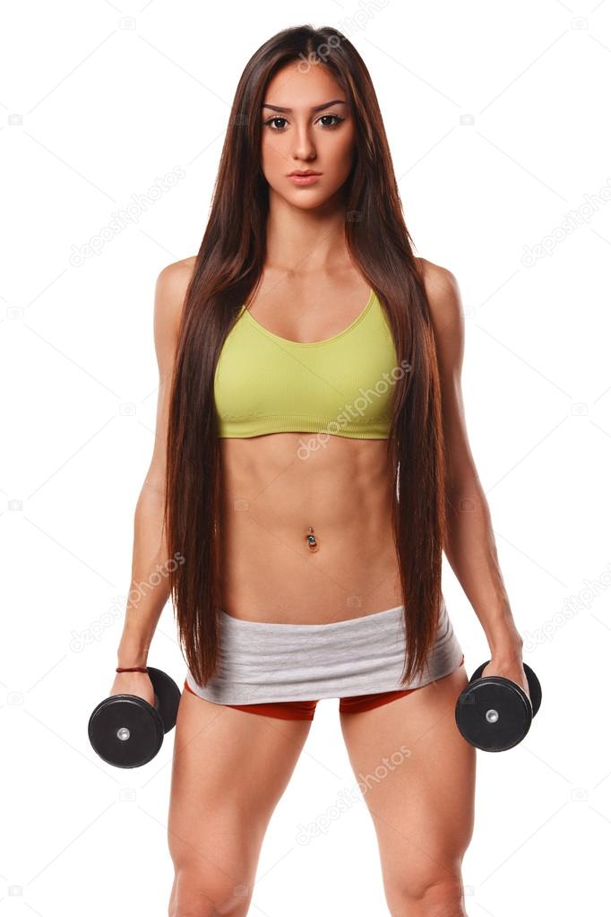 Beautiful athletic woman with long hair working out with dumbbells. Fitness  girl showing muscular athletic body, abs. Isolated on white background  Stock Photo by ©Nikolas_jkd 62089053