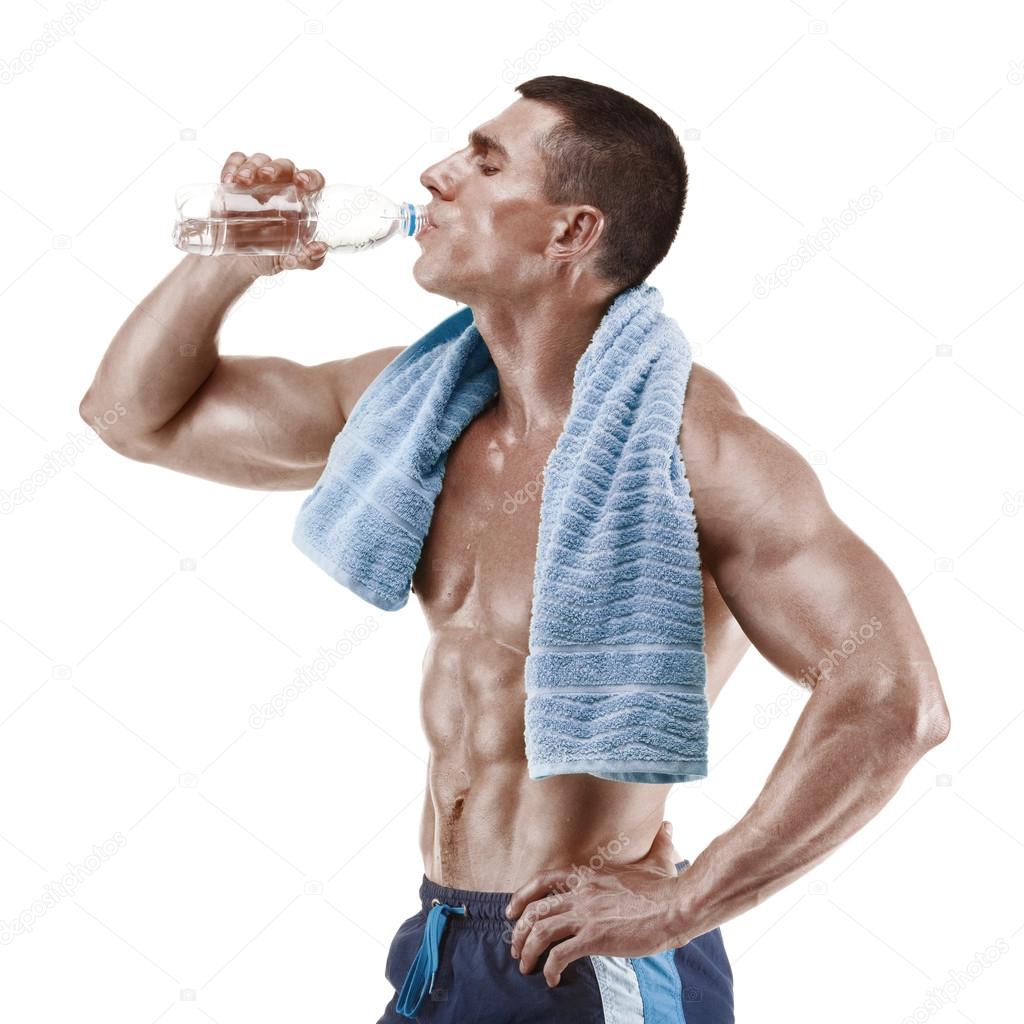 Muscular man drinking water with blue towel over neck, isolated on white background