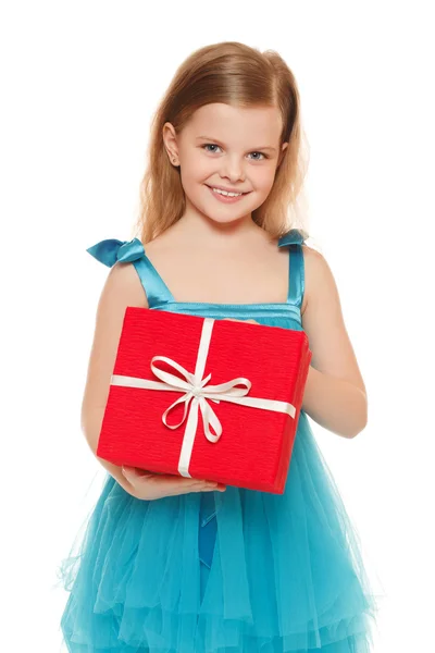 Little cute girl in blue dress holding a gift box, isolated on the white background — Stock Photo, Image