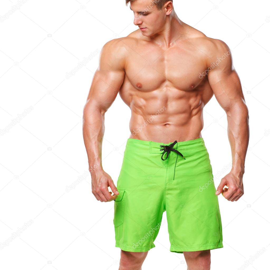 Sexy athletic man showing muscular body and sixpack abs, isolated over white background. Strong male nacked torso