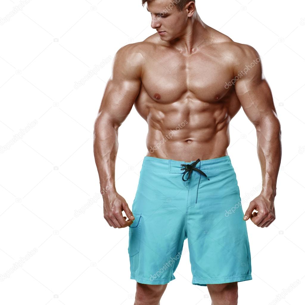 Sexy athletic man showing muscular body and sixpack abs, isolated over white background. Strong male nacked torso