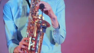 Saksafon player profesyonel ışık ile sahnede gerçekleştirir. Yakın çekim.