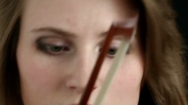 Siyah bir zemin üzerine beyaz kemancı kız.