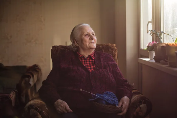 Portrait of an old lonely human who looks out the window — Stock Photo, Image