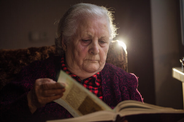 Old human reading a book.