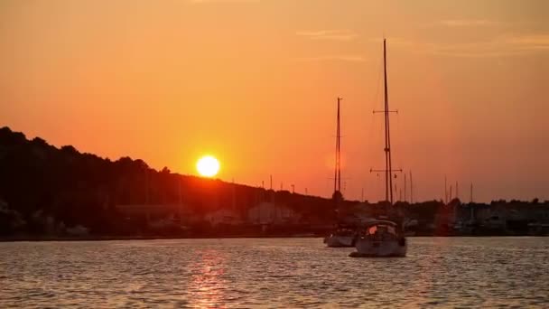 Two yachts in the sea at sunset on a background of mountains — Stock Video