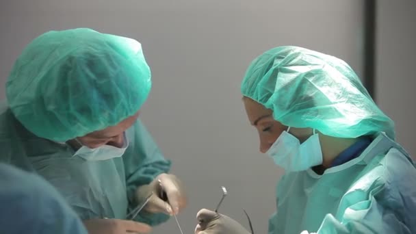 RUSSIA, S.PETERSBURG 2013: Plastic surgeon and an assistant make man operation — Stock Video