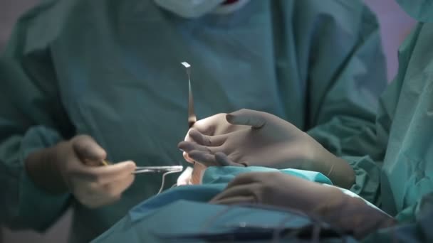 RUSSIA, S.PETERSBURG 2013: Plastic surgeon and an assistant make man operation — Stock Video