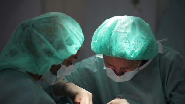 RUSSIA, S.PETERSBURG 2013: Plastic surgeon and an assistant make man operation — Stock Video