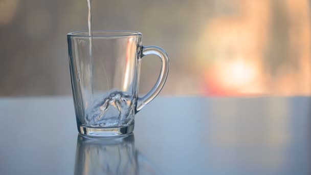 Hot water over tea in transparent glass cup — Stock Video