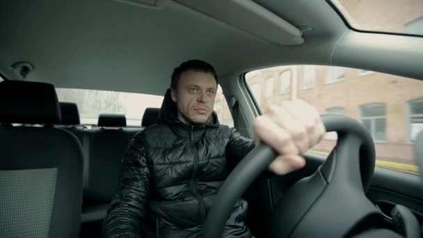 Serious man driving a car — Stock Video
