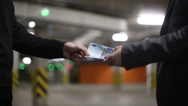 Männer reichen einander Geld-Euro-Scheine und schütteln Hände. Zeitlupe. Bokeh-Hintergrund — Stockvideo