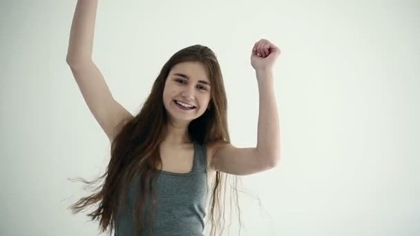 Menina adolescente atraente torcendo e alegre. Movimento lento — Vídeo de Stock