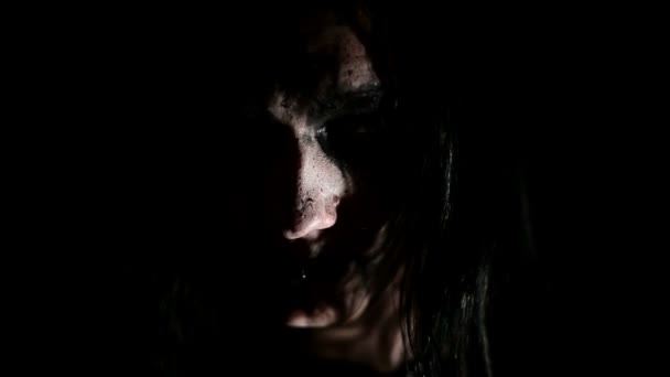 Vocalist of black metal band. Close up face at dark background — Stock Video