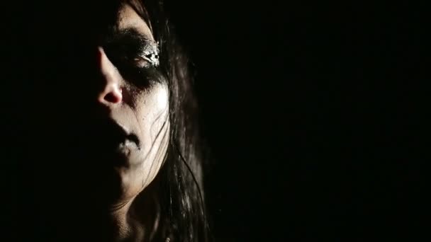 Vocalist of black metal band. Close up face at dark background — Stock Video