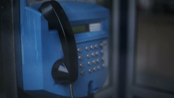 Man att göra ett telefonsamtal på offentlig telefonkiosk i staden — Stockvideo