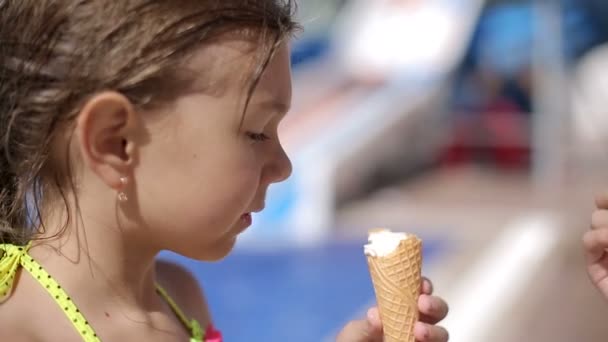 Niño comiendo helado después de nadar en la piscina — Vídeo de stock