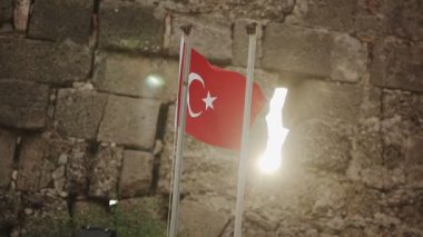 Gün batımında taş duvar arka plan üzerinde Türk bayrağı