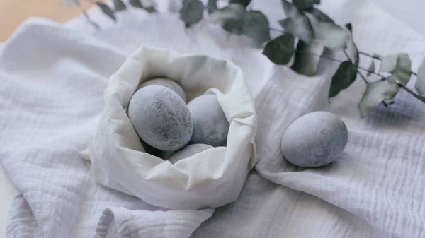Easter eggs painted with natural dye  on textured fabric.