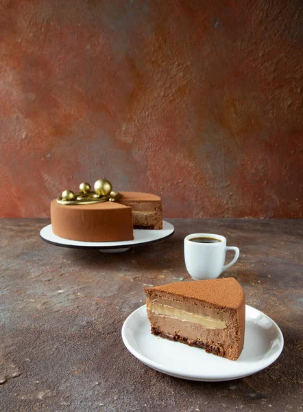 Delicious chocolate mousse cake with a cup of hot coffee on the table with an unusual texture table - dessert in the cafe