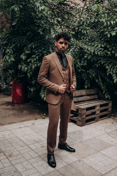 business suit on a dark-skinned man, tuxedo, three-piece suit