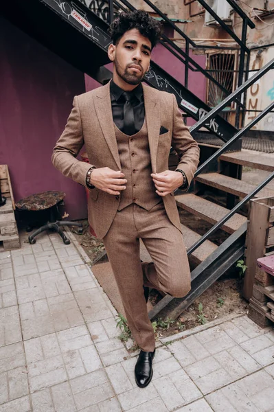 business suit on a dark-skinned man, tuxedo, three-piece suit