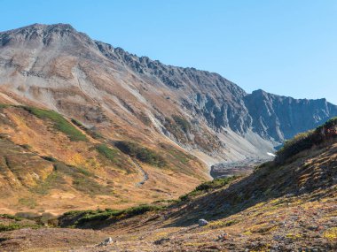 View of the volcano crater Vachkazhets mountain range. The remains of a large volcano crater attracts tourists with its unusual beauty. Kamchatka Peninsula, Russia.