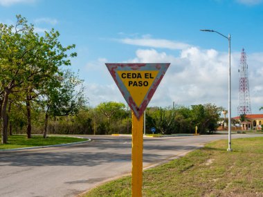 Kavşak çatalının yanında yol tabelası var. Üçgen levhada İspanyolca 