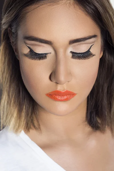 Portrait of a beautiful woman with orange lipstick — Stock Photo, Image