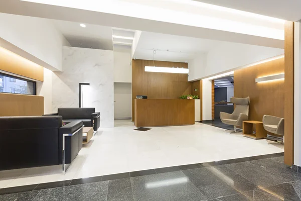 Reception area with wooden reception desk — Stock Photo, Image