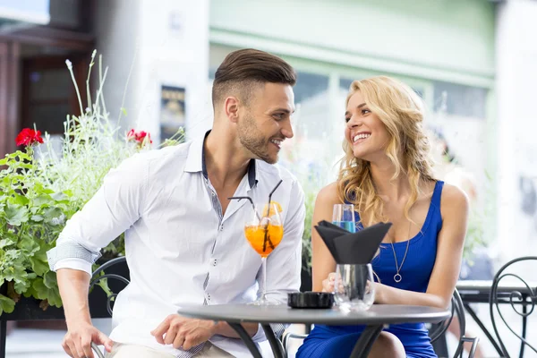 Beautiful couple at the bar drinking cocktails