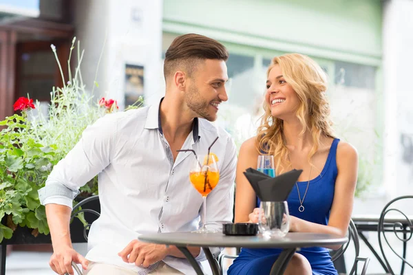 Beautiful couple at the bar drinking cocktails