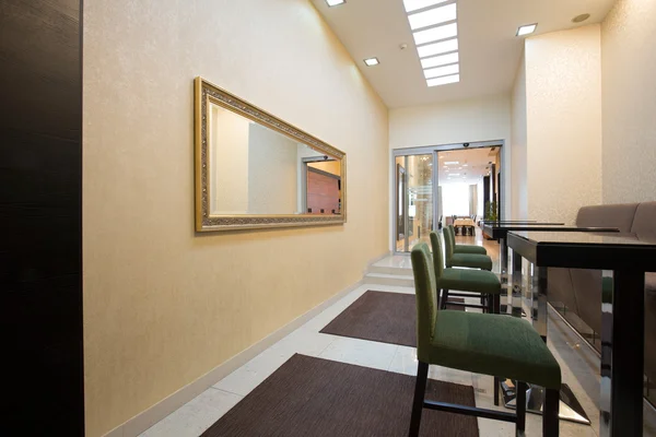 Hotel corridor with bar stools and tables — Stock Photo, Image