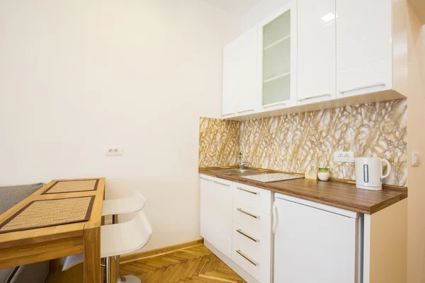 Kitchen in a modern studio apartment — Stock Photo, Image