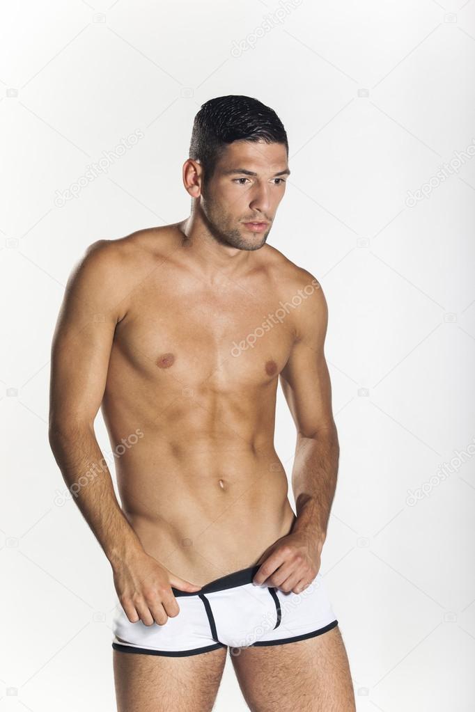Sexy muscular man pulling down his boxers